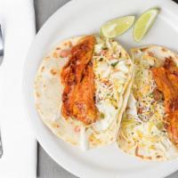Fish Tacos · Two tacos with tilapia and tomatoes, served with rice, lettuce, pico de gallo, cheese and le...