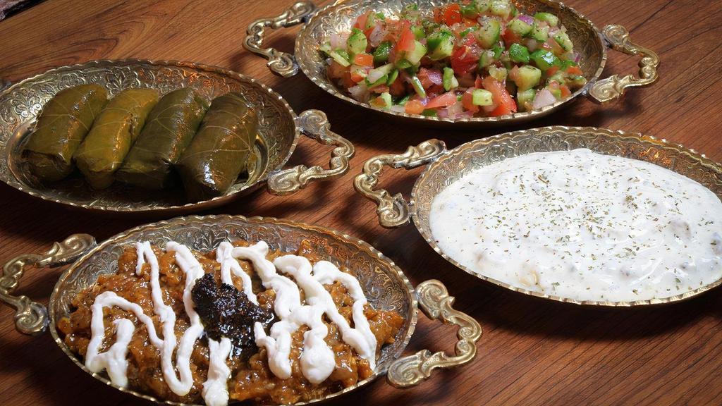 Combination Platter /  پیش غذا شهرزاد · A combination of Dolmeh, Kashk-e-Bademjan (eggplant), Shirazi Salad, and Mast-O-Khiar.