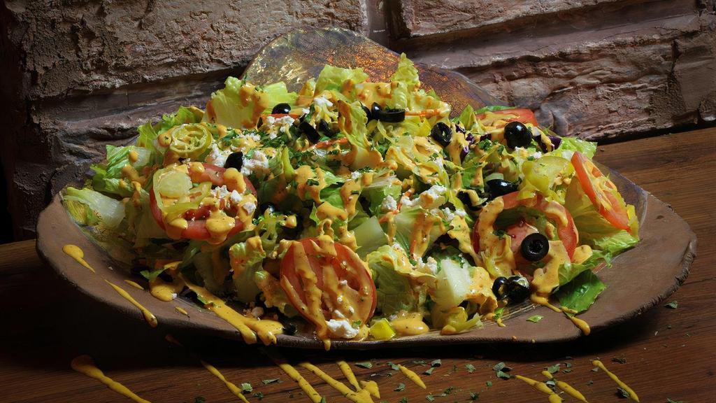 House Salad /  سالاد مخصوص · Heart of romaine lettuce, cucumbers, tomatoes, red onions, olives, pepperoncinis, red cabbage, shredded carrots and topped with feta cheese.