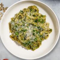 Manipesto Fettuccine Pasta · (Vegetarian) Fresh fettuccine pasta cooked in a pesto sauce and topped with black pepper, pa...