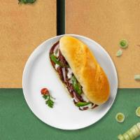 Philly Willy Steak Sandwich · Beef Steak, Green Peppers, Onions & Seasoning with Mayo & Cheese on a hero.
