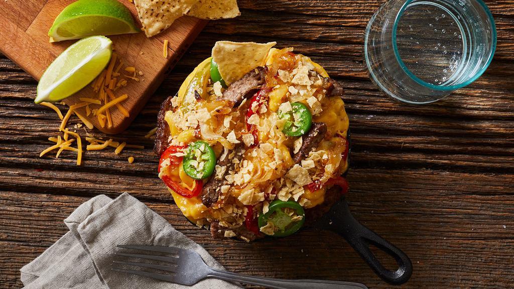 Tex Mex Mac & Cheese · Elbow macaroni with our classic cheese blend, chopped steak, onions, bell peppers, and jalapenos, topped with tortilla chips.
