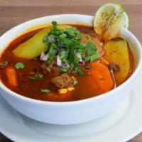 Caldo De Res · Beef soup with veggies, carrots, onions, corn, zucchini and cilantro.