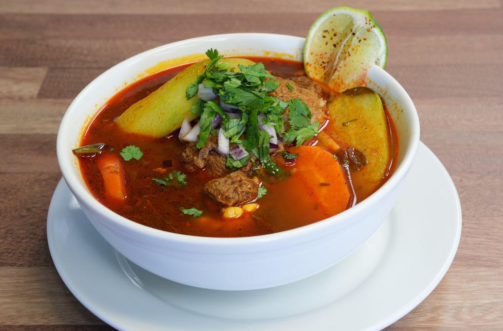 Caldo De Res · Beef soup with veggies, carrots, onions, corn, zucchini and cilantro.