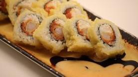 Golden California Roll · In CA roll top with salmon, whole roll deep fried, eel sauce, and miso soup.