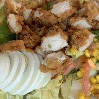 Fried Chicken Salad · crispy chicken, iceberg lettuce, tomato, fire roasted corn, cucumber, avocado, honey dijon v...