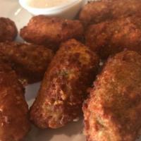 Jalapeño Poppers (6) · Cream cheese filled breaded jalapeños with ranch or bleu cheese.