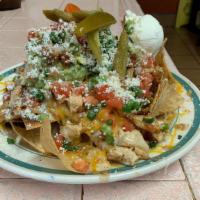 Loaded Nachos · Fresh house chips, topped with beans, cheese, jalapenos, guacamole, sour cream &pico de gallo.