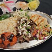 Beefin' Shawarma Plate · Doner style beef shawarma that has been marinated over rice. Served with our cucumber and to...
