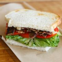 The Blt · Locali-made coconut bacon/ romaine/ tomato/ mustard/ vegan mayo on sourdough bread.