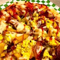 Breakfast Naan Pizza · Bacon, Scrambled Eggs, Mozzarella Cheese, Pakora Fries, Basil Pizza Sauce and a Drizzle of T...