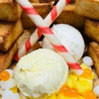 Mango Madness · Mango and vanilla ice cream, mango popping boba, mango fruit, sweet milk glaze, mini mochis.