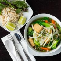 Vegetable Pho (Gf)(V) · A delicious blend of bok choy, carrots, mushrooms, zucchini, and tofu in a rich chicken, bee...