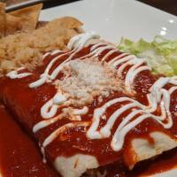 Enchiladas De Carne · Shredded beef topped with roasted tomato red sauce, crema and queso fresco.