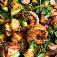Spicy Shrimp Salad · Grilled shrimp tossed with spicy thai herbs and a pepper-roasted vinaigrette, served on a be...