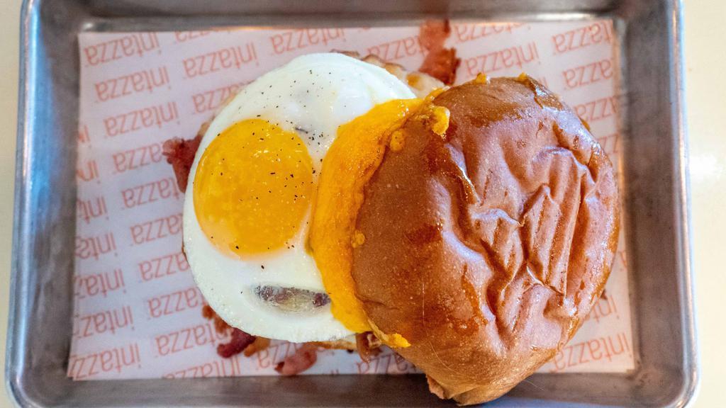 Good Morning America · Local favorite. Fried Egg, Crumbled Bacon, Cheddar, Provolone, and Tomato, Garlic Aioli on a Gourmet Bun.
