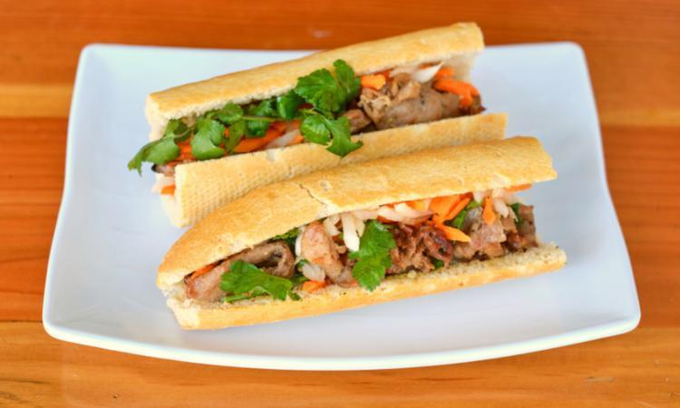 Banh Mi Thit/Pork · Grilled Pork 12” baguette warm french baguette served with house mayo, pickled. carrots/daikon, cilantro and jalapenos.