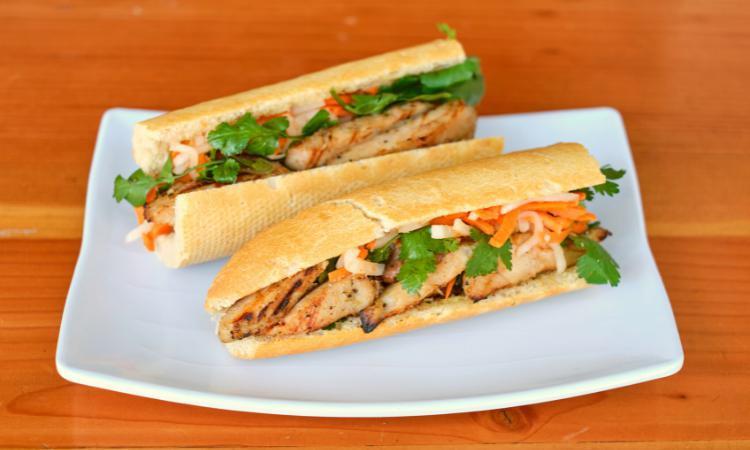 Banh Mi Ga/Chicken · Grilled Lemongrass Free Range Chicken 12” baguette warm french baguette served with house mayo, pickled. carrots/daikon, cilantro and jalapenos.