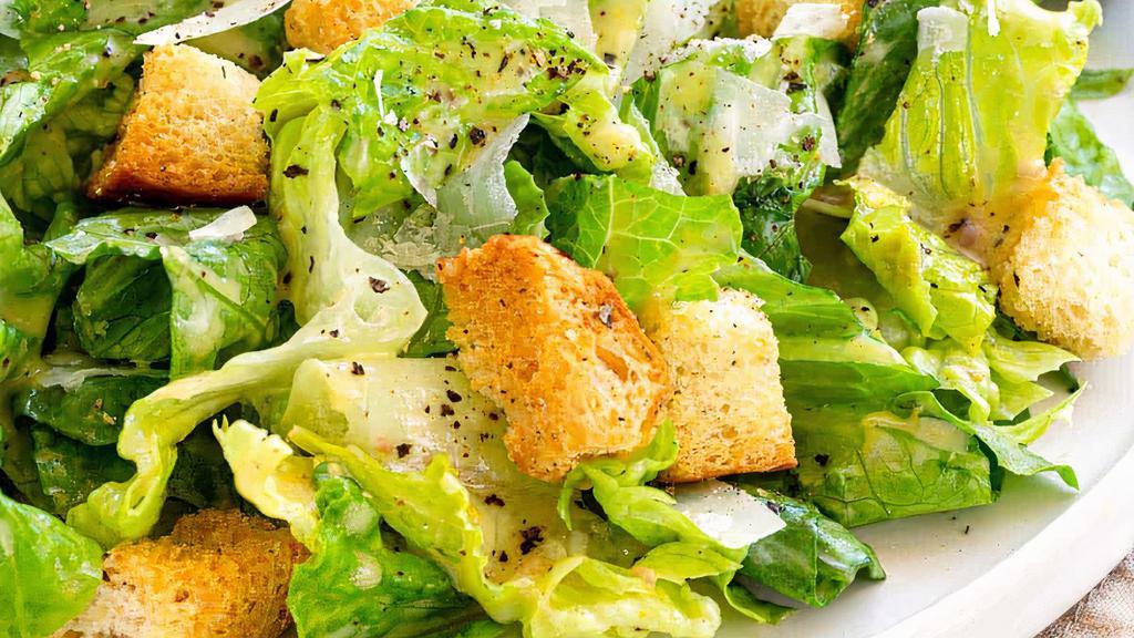 Caesar Salad · Crisp Romaine Lettuce, Croutons, Parmesan Cheese, tossed is house Caesar Dressing