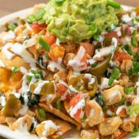 Nachos Supreme · Grilled chicken breast or carne asada with homemade tortilla chips over refried beans, mozza...