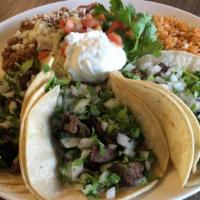 Tacos De Puesto (Street Tacos) · Three soft corn tortillas filled with grilled chicken breast or beef brisket with onion and ...