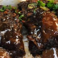 Adobo Pork Ribs Silog · Pork ribs braised in garlic, soy, vinegar, and spices. Served with garlic rice and soft boil...