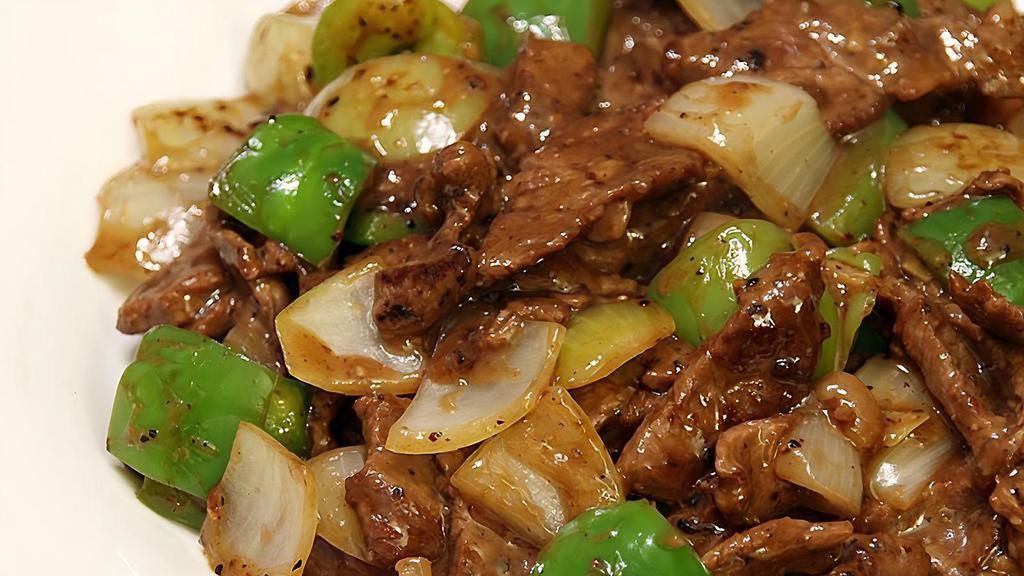 Pepper Steak With Onions · Served with white rice.