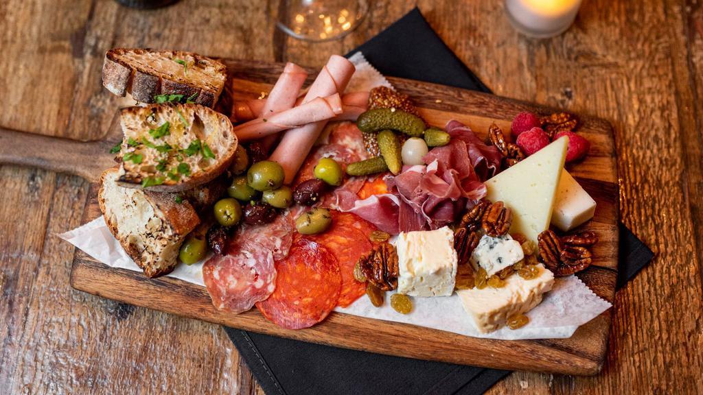 Artisan Cheeses & Cured Meats Board · Aged cheeses and cured meats, seasonal garnishes, marinated olives, mustard, grilled rustic bread.