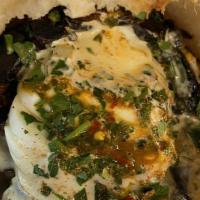 Sabich · Filled with hard boiled egg, eggplant, israeli salad, tahini, parsley.