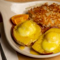 Eggs Benedict, And Potatoes · Slices of ham on an English muffin topped with 2 poached eggs covered with Hollandaise. Incl...