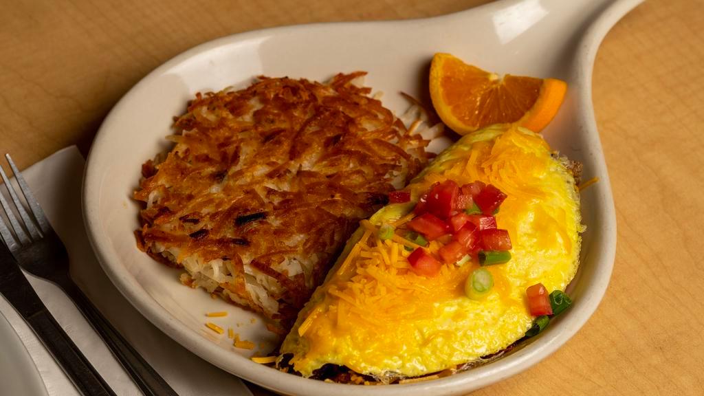 Ham N Cheese Omelet · Stuffed with diced ham and cheddar cheese. Your choice of potatoes and either toast or biscuits and gravy.