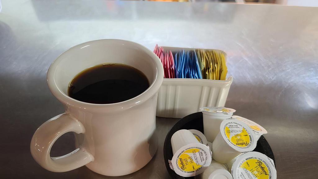 Coffee · A hot coffee in a to go cup. Please specify if you would like creamer we have 1/2 and 1/2, hazelnut, and French Vanilla.  We also have artificial sweeteners; the yellow, pink, and blue.