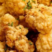 Popcorn Chicken · Bite-sized pieces of boneless chicken lightly battered and deep fried.