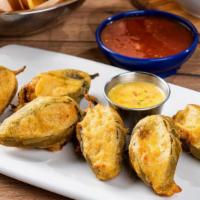 Firecracker Stuffed Jalapeños · Handmade, tempura-fried jalapeños filled with mixed cheese and chicken. Served with our sign...