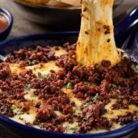 Melted Queso Fundido · Melted Mexican and Jack cheeses mixed tableside with caramelized onions, poblano peppers, an...
