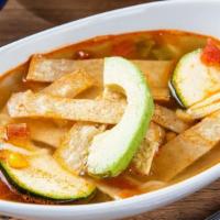 Chicken Tortilla Soup · Homemade chicken broth loaded with chicken tinga, rice, zucchini, and Jack cheese, topped wi...