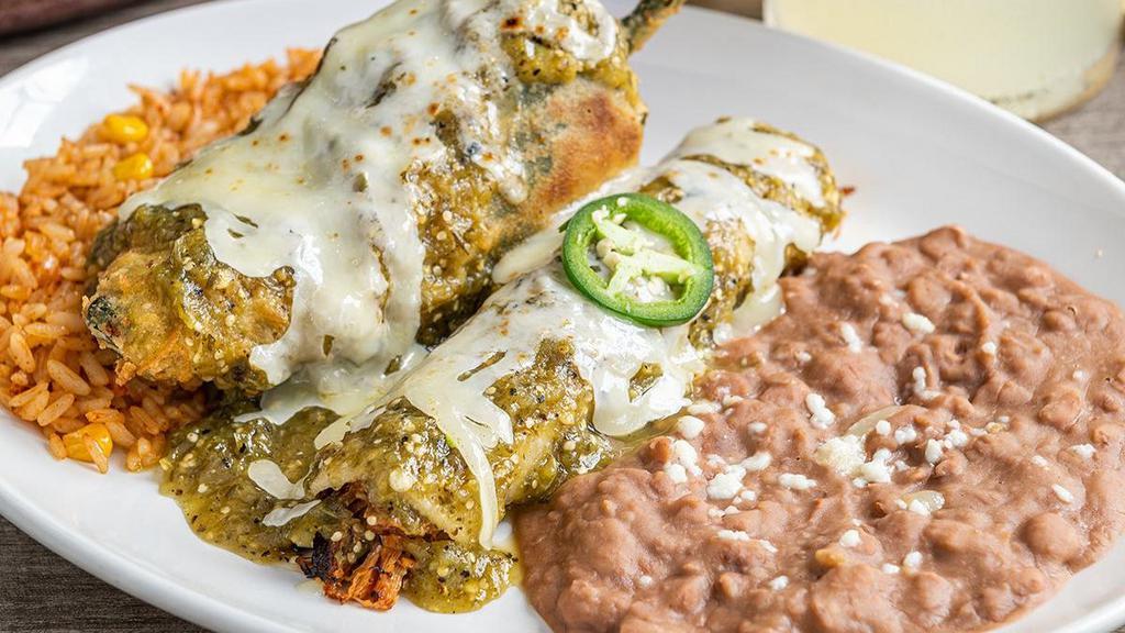 New Mexico · Cheese chile relleno and carnitas enchilada, topped with salsa verde. Served with Mexican rice and choice of beans.