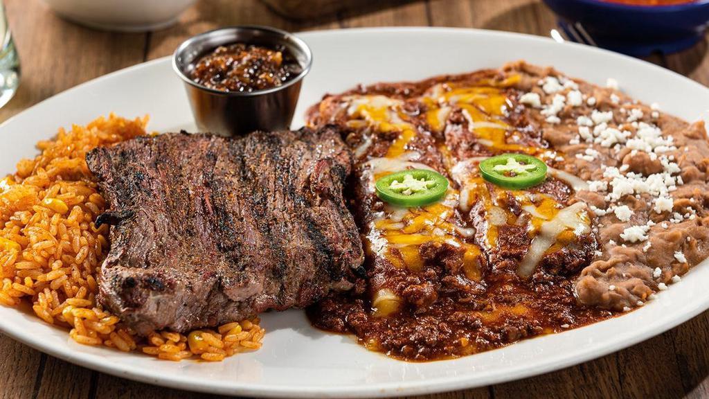 Ranchiladas · A 9 oz. mesquite-grilled steak served with roasted red chile tomatillo salsa, plus two hand-rolled cheese enchiladas smothered in chile con carne. Served with Mexican rice and choice of beans.