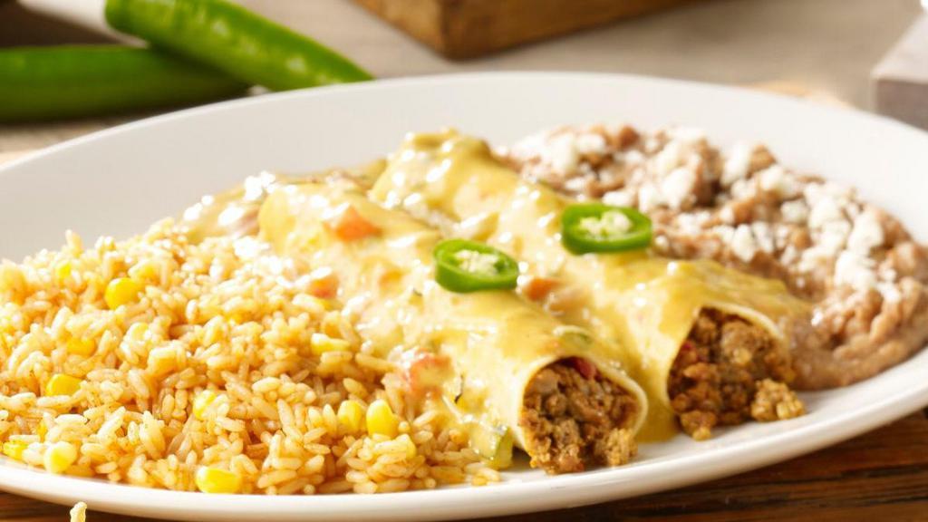 Border Queso Beef Enchiladas · Two seasoned ground beef enchiladas topped with our border queso. Served with Mexican rice and choice of beans.