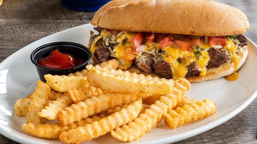 Queso Steak Torta · Fajita steak with Mexican white cheese, pico de gallo, lime chimichurri and our Signature Queso in a toasted bolillo roll. Served with fries.