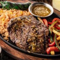 Carne Asada · A 9oz. marinated and seasoned mesquite-grilled steak served on a skillet with seasoned butte...