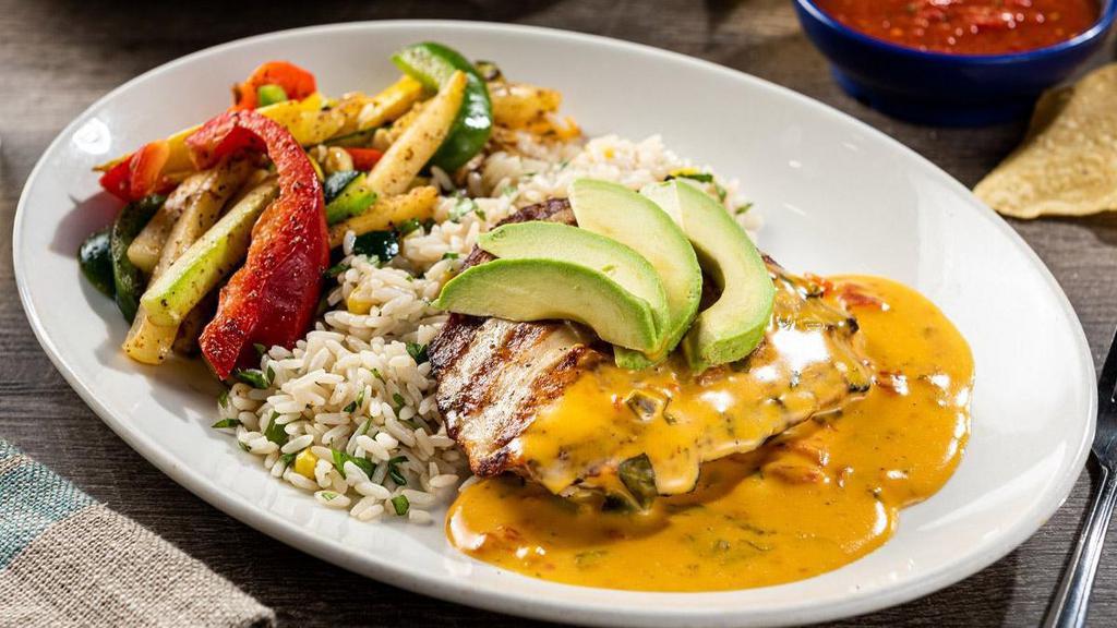 Grilled Queso Chicken · Mesquite-grilled chicken breast topped with our signature queso and fresh sliced avocado. Served with sautéed vegetables and cilantro lime rice.