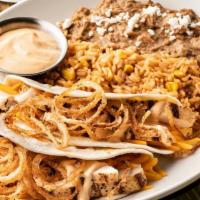 Southwest Chicken Tacos · Mesquite-grilled chicken, cheddar cheese, creamy red chile sauce and fried onion strings in ...