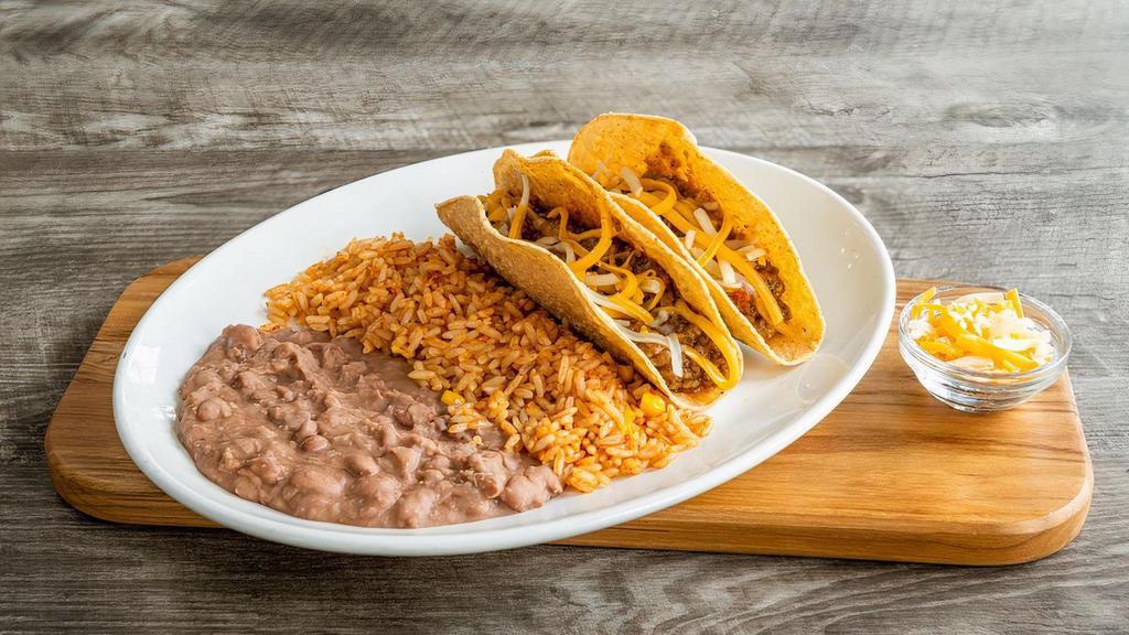 Kids Taco Plate · Two soft or crispy tacos with seasoned ground beef and mixed cheese. Served with Mexican rice and refried beans.