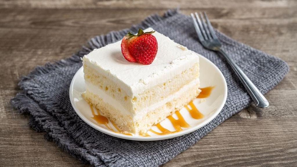 Tres Leches Cake · A Mexican tradition. A light cake soaked in three kinds of sweet milk,  topped with whipped cream and strawberry.