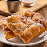 Two Sopapillas · Mexican pastries coated in cinnamon-sugar. Served with honey or chocolate sauce for dipping.