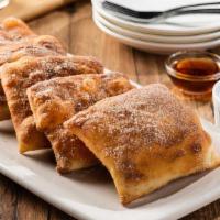 Sopapillas · 1330 cal. Five Mexican pastries coated in cinnamon-sugar. Served with honey and chocolate sa...
