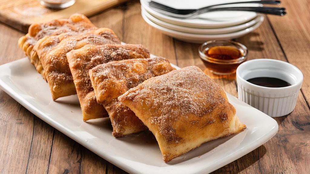 Sopapillas · Five Mexican pastries coated in cinnamon-sugar. Served with honey and chocolate sauce for dipping.