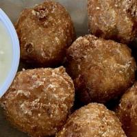 Mexican Street Corn Bites · Battered corn kernels in a cheese dipping sauce.
