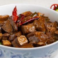 Hunan Red Braised Pork Belly 湖南红烧肉 · Pork belly braised with red chili in hot and spicy Hunan sauce over sauteed lettuce.